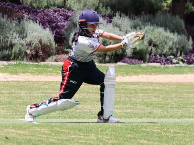 Cricketing star Anushka hits a ball in her cricket gear.